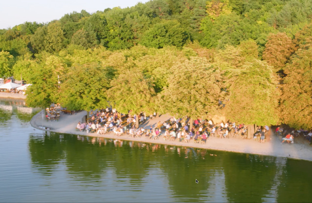 Outdoor event venue overlooking forest and lake