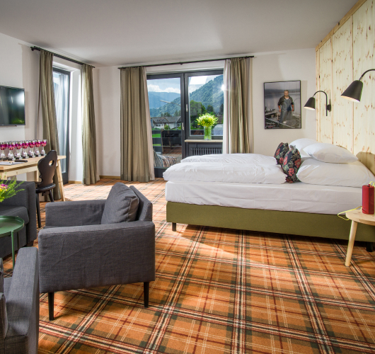 Hotel room interior with mountain view, set up for group accommodation